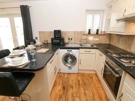 A kitchen with a washing machine and countertop space at Red Kite Cottage Haverfordwest