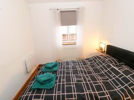 A bedroom with a bed and towels at Red Kite Cottage in Haverfordwest