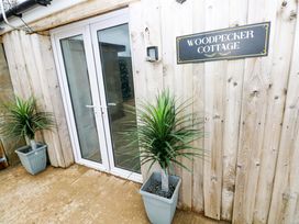 An outdoor area with double doors and potted plants at Woodpecker Cottage in Haverfordwest