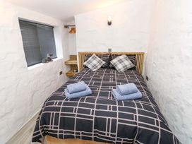 A bedroom with a bed and towels at Woodpecker in Haverfordwest