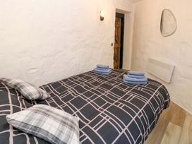 A bedroom with a bed and towels at Woodpecker in Haverfordwest