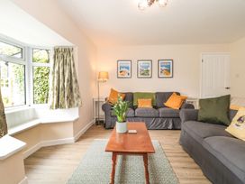 A living room with sofas and a coffee table at Ammerham Farm Cottage in Ammerham near Winsham
