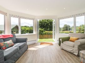 A sitting room with sofas and large windows at Ammerham Farm Cottage Ammerham near Winsham