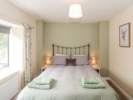 A bedroom with a bed and curtains at Ammerham Farm Cottage Ammerham near Winsham