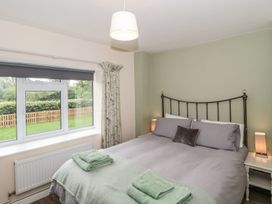 A bedroom with a bed and window at Ammerham Farm Cottage Ammerham near Winsham