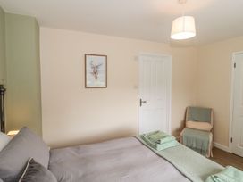 A bedroom with a bed and a chair at Ammerham Farm Cottage Ammerham near Winsham