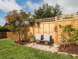 A garden with a bench and cushions at Ammerham Farm Cottage Ammerham near Winsham