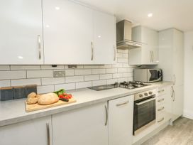 A kitchen with cabinets and appliances at Ocean Wave in Greenhill