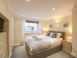 A bedroom with a bed and television at Ocean Wave in Greenhill