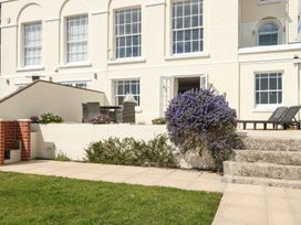 An outdoor area with chairs and a table at Ocean Wave in Greenhill
