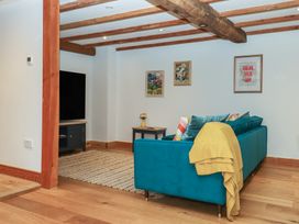 A living room with a sofa and TV at Pylemoor Cottage in Washfield near Tiverton