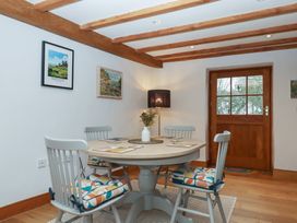 A dining room with a table and chairs at Pylemoor Cottage in Washfield near Tiverton