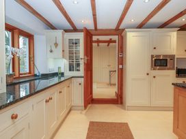 A kitchen with cabinets and a microwave at Pylemoor Cottage Washfield near Tiverton