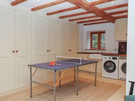 A utility room with a table tennis table and appliances at Pylemoor Cottage Washfield near Tiverton
