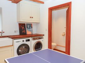 A laundry room with a washing machine and dryer at Pylemoor Cottage Washfield near Tiverton