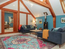A living room with sofas and a coffee table at Pylemoor Cottage in Washfield near Tiverton