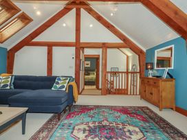 A living room with a sofa and rug at Pylemoor Cottage, Washfield near Tiverton