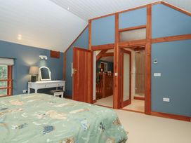 A bedroom with a bed and dresser at Pylemoor Cottage Washfield near Tiverton