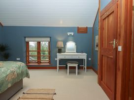 A bedroom with a vanity table and window at Pylemoor Cottage in Washfield near Tiverton