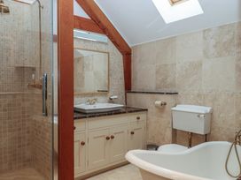 A bathroom with a shower, bathtub, sink, and toilet at Pylemoor Cottage in Washfield near Tiverton