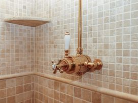 A shower valve and shelf in a bathroom at Pylemoor Cottage Washfield near Tiverton
