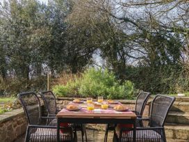 A garden setting with a table and chairs at Pylemoor Cottage in Washfield near Tiverton