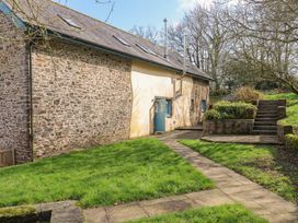 A garden with a pathway and steps at Pylemoor Cottage in Washfield near Tiverton