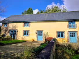 A house with blue windows and a door at Pylemoor Cottage Washfield near Tiverton