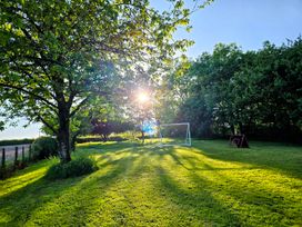 An outdoor area with a goalpost and trees at Pylemoor Cottage in Washfield near Tiverton
