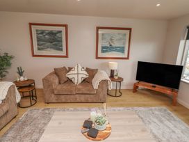 A living room with a sofa and TV at Tigh-Na-Mara Retreat