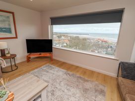 A living room with a large window offering a view at Tigh-Na-Mara Retreat