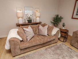 A living room with a sofa and decorative items at Tigh-Na-Mara Retreat