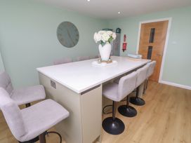 A kitchen with a large island and bar stools at Tigh-Na-Mara Retreat