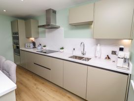 A kitchen with cabinets and appliances at Tigh-Na-Mara Retreat 