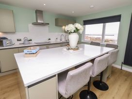A kitchen featuring an island with bar stools at Tigh-Na-Mara Retreat