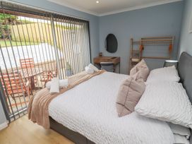 A bedroom with a bed and bedside table at Tigh-Na-Mara Retreat