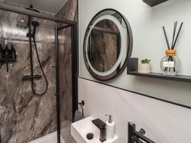A bathroom with shower and sink at Tigh-Na-Mara Retreat