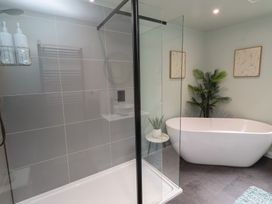 A bathroom with a shower, bathtub, sink, and towels at Tigh-Na-Mara Retreat