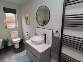 A bathroom with a toilet, wash basin and plants at Tigh-Na-Mara Retreat