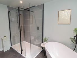 A bathroom with a shower and bathtub at Tigh-Na-Mara Retreat