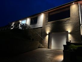 A house exterior with a garage door and outdoor lighting at Tigh-Na-Mara Retreat in Spittal