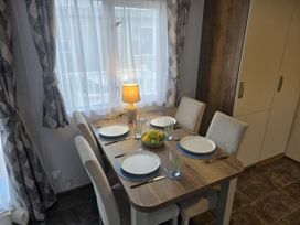 A dining room with a table set for four at River Meadow 61 Northampton