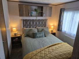 A bedroom with a bed and nightstand at River Meadow 61 Northampton