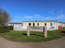 A sign and house at The Waterfront in Allhallows