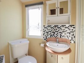 A bathroom with a sink and toilet at Ocean Breeze Escape in Allhallows