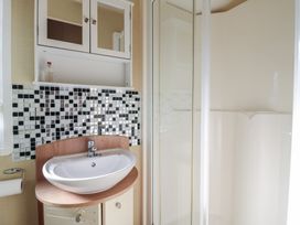 A bathroom with a sink and shower at Ocean Breeze Escape Allhallows