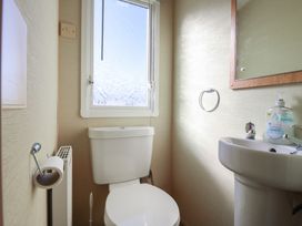 A bathroom with a toilet and sink at Ocean Breeze Escape in Allhallows