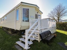 A mobile home with a deck and stairs at Ocean Breeze Escape in Allhallows