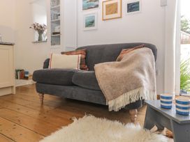 A living room with a sofa and side table at The Old Studio in Penzance