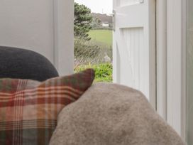 A view of a landscape through a door from a living room at The Old Studio in Penzance
